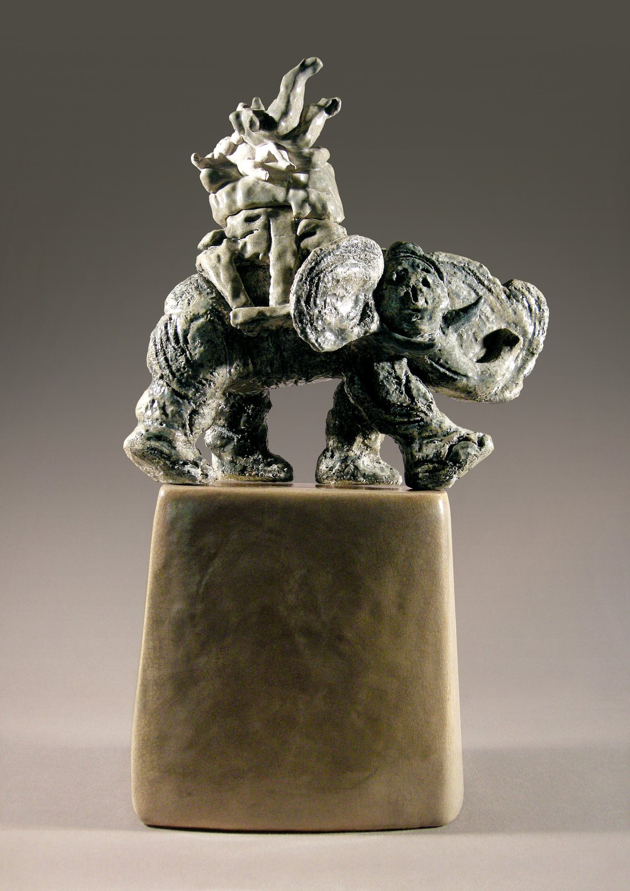 Walking elephant carrying a rider, in silver-grey glazed stoneware