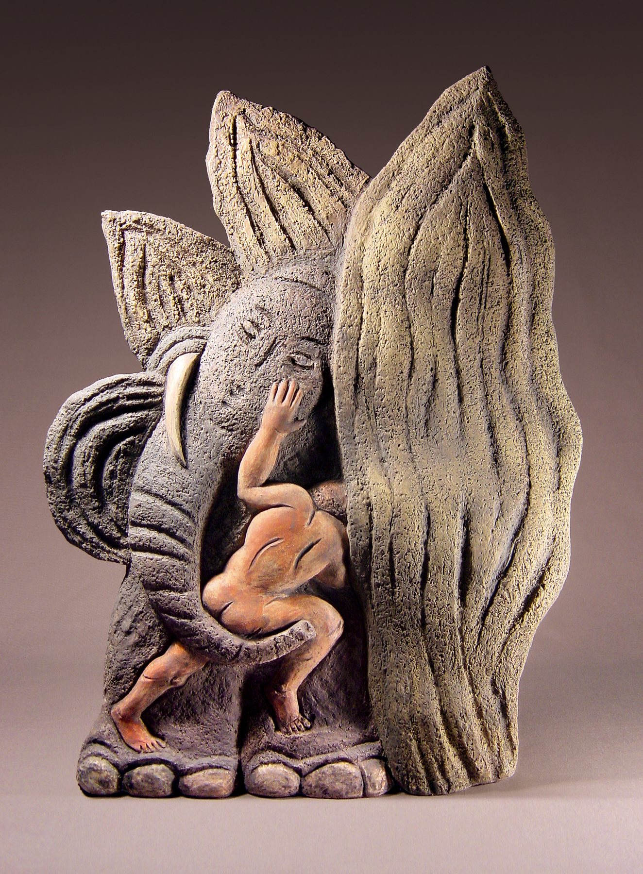A pink figure hides among large leaves and an elephant in painted terracotta