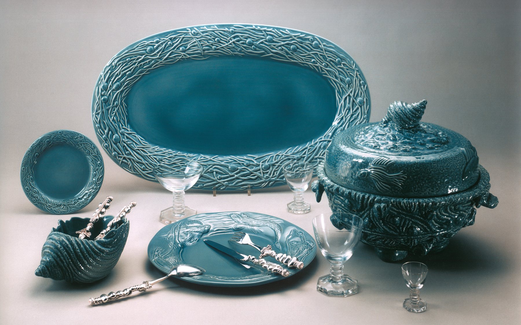 Turquoise earthenware fish service: serving dish, tureen and plates